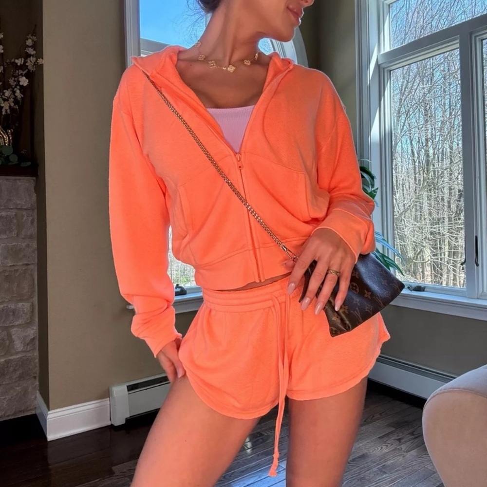 SKIMS electric orange 2 piece shorts and zip up sweatshirt